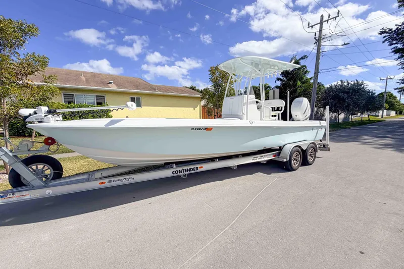  Yacht Photos Pics 2023 Contender 26 Bay boat on trailer, parked on a sunny residential street.
