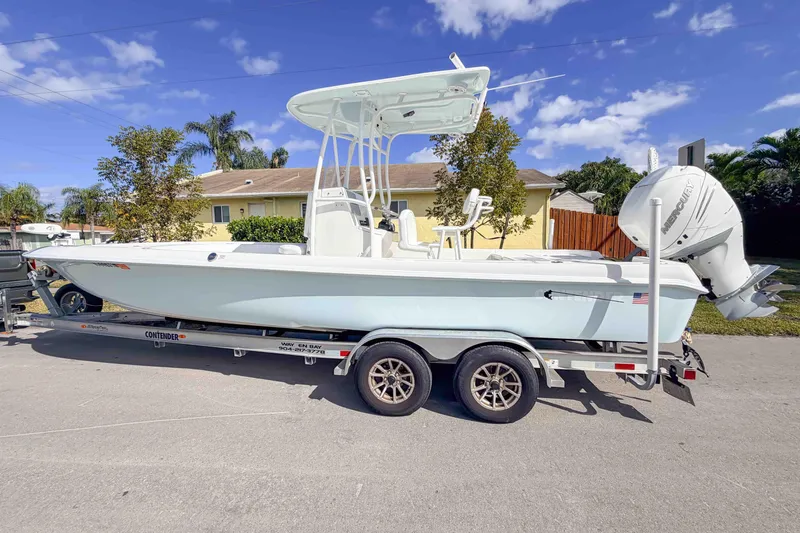  Yacht Photos Pics 2023 Contender 26 Bay boat on trailer, parked outdoors under a clear blue sky.