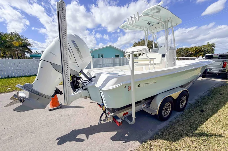  Yacht Photos Pics 2023 Contender 26 Bay boat with Mercury engine on trailer, parked outdoors.