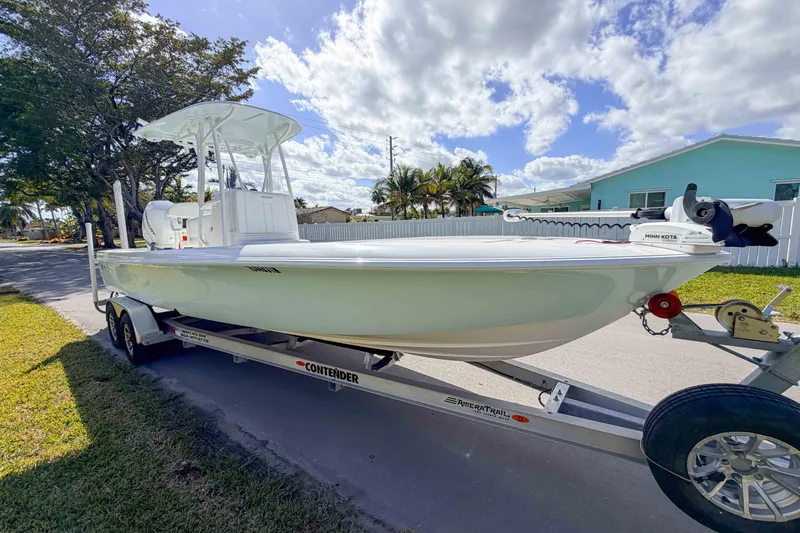  Yacht Photos Pics 2023 Contender 26 Bay boat on trailer, parked in a sunny residential area.