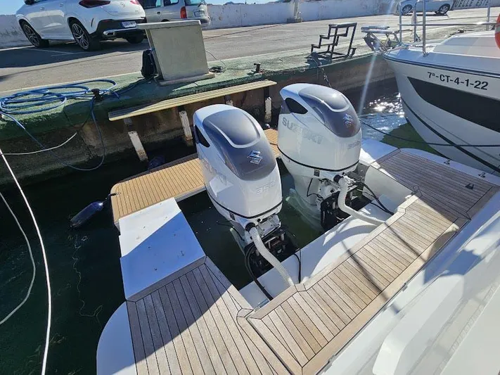  Yacht Photos Pics 2024 Sealine C390V boat with dual Suzuki outboard motors docked at a marina.