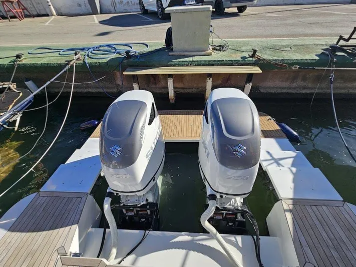  Yacht Photos Pics 2024 Sealine C390V boat with dual Suzuki outboard engines docked at marina.