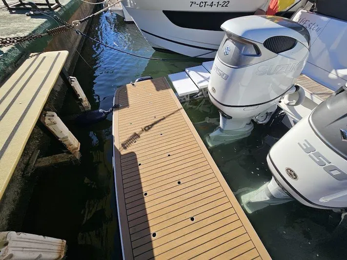  Yacht Photos Pics 2024 Sealine C390V boat with twin Suzuki 350 outboard engines docked at a marina.
