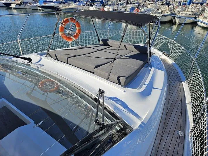  Yacht Photos Pics 2024 Sealine C390V yacht with sunbathing area and canopy, docked in marina.