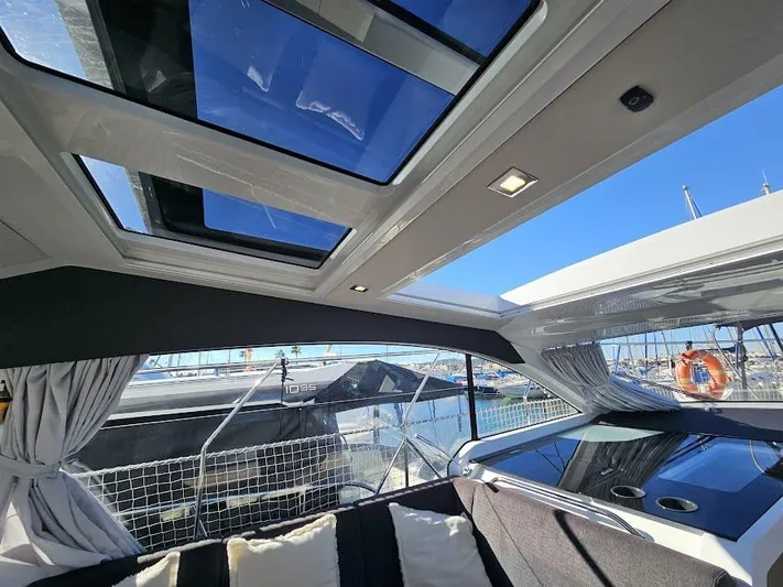  Yacht Photos Pics 2024 Sealine C390V yacht interior with panoramic sunroof and marina view.