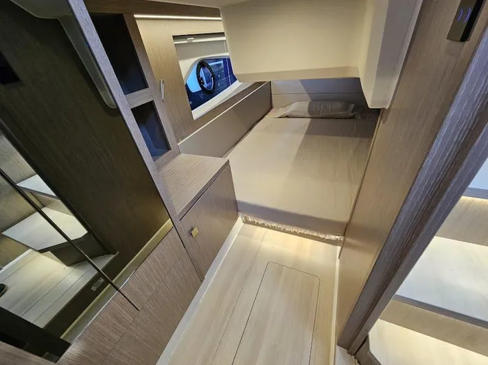  Yacht Photos Pics 2024 Sealine C390V yacht interior cabin with modern wood finish and cozy bed.