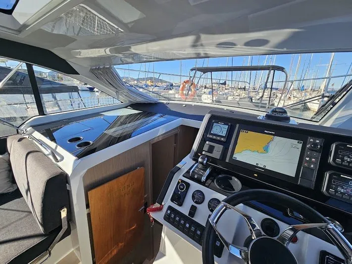  Yacht Photos Pics 2024 Sealine C390V yacht cockpit with modern navigation system and steering wheel.