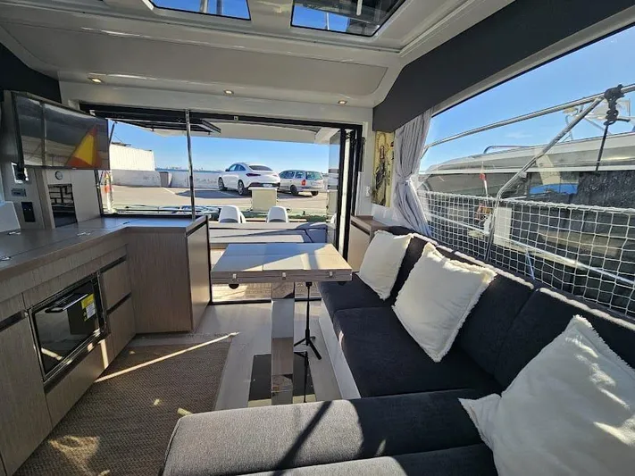  Yacht Photos Pics 2024 Sealine C390V yacht interior with modern kitchen, dining area, and comfortable seating.