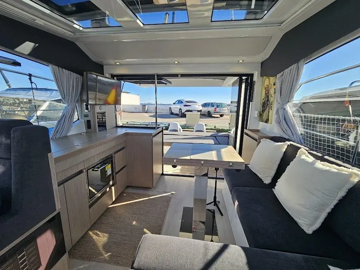  Yacht Photos Pics Luxurious interior of 2024 Sealine C390V yacht with modern furnishings and panoramic windows.
