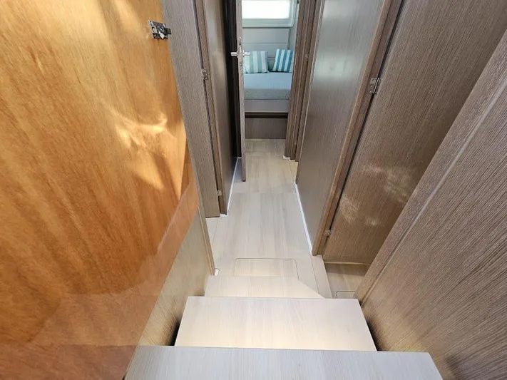  Yacht Photos Pics 2024 Sealine C390V yacht interior hallway with wooden finishes and modern design.