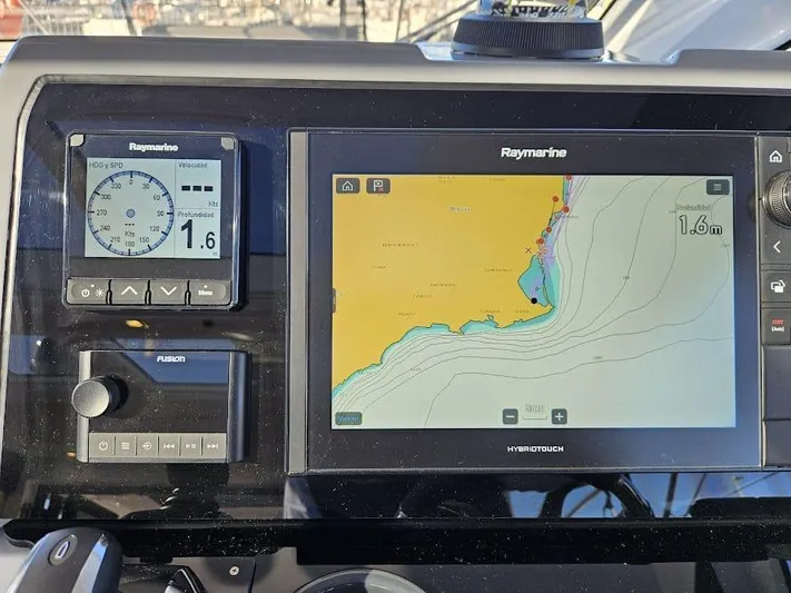  Yacht Photos Pics Raymarine navigation system on 2024 Sealine C390V boat dashboard, displaying nautical charts.
