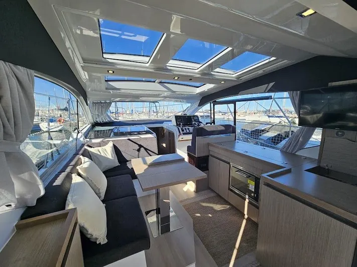  Yacht Photos Pics 2024 Sealine C390V yacht interior with modern design, skylights, and marina view.