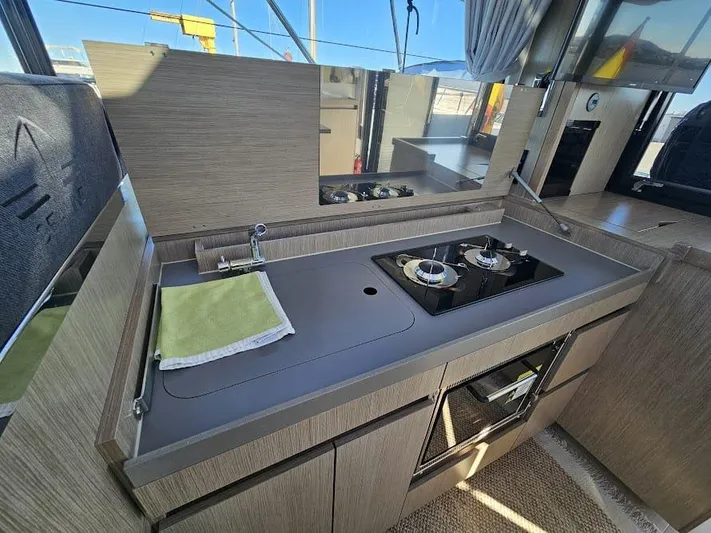  Yacht Photos Pics 2024 Sealine C390V yacht kitchen with modern stove and sleek cabinetry.