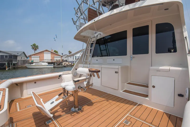 High Interest Yacht Photos Pics 2002 Cabo Convertible Painted boat with teak deck and fishing chair.