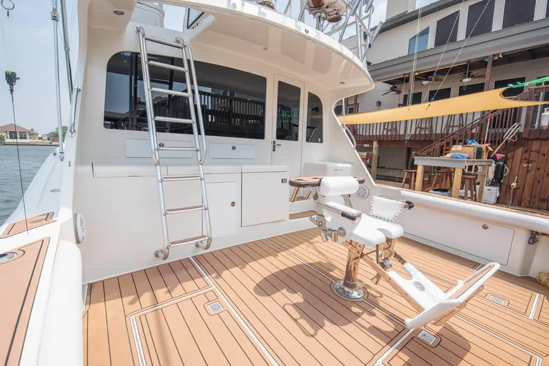 High Interest Yacht Photos Pics 2002 Cabo Convertible Painted boat with teak deck and fishing chair.