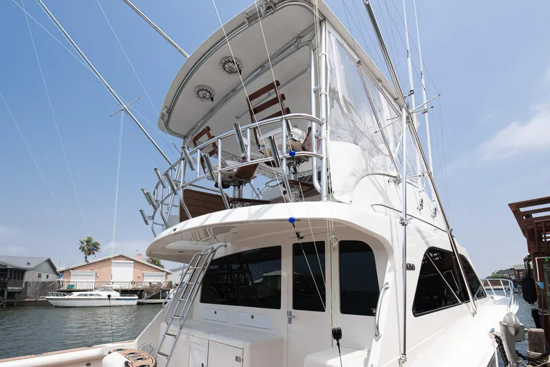 High Interest Yacht Photos Pics 2002 Cabo Convertible Painted yacht docked at marina.