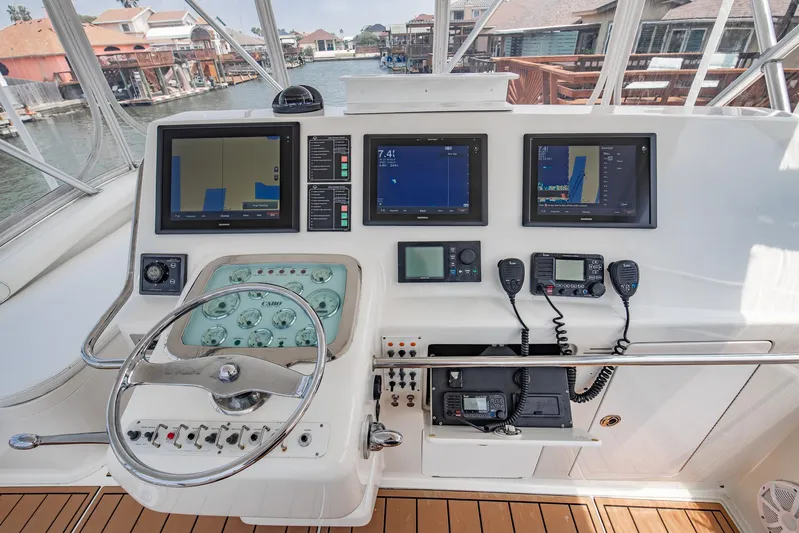 High Interest Yacht Photos Pics 2002 Cabo Convertible Painted boat helm with navigation screens and controls.