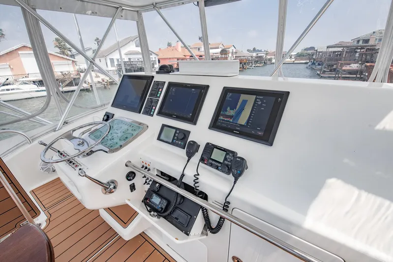 High Interest Yacht Photos Pics 2002 Cabo Convertible Painted boat helm with navigation screens and controls.