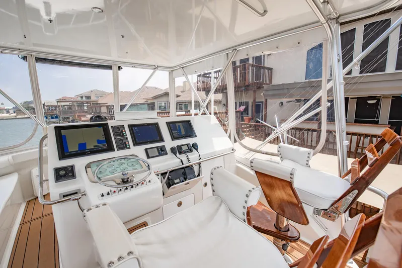 High Interest Yacht Photos Pics 2002 Cabo Convertible Painted boat helm with modern navigation equipment.