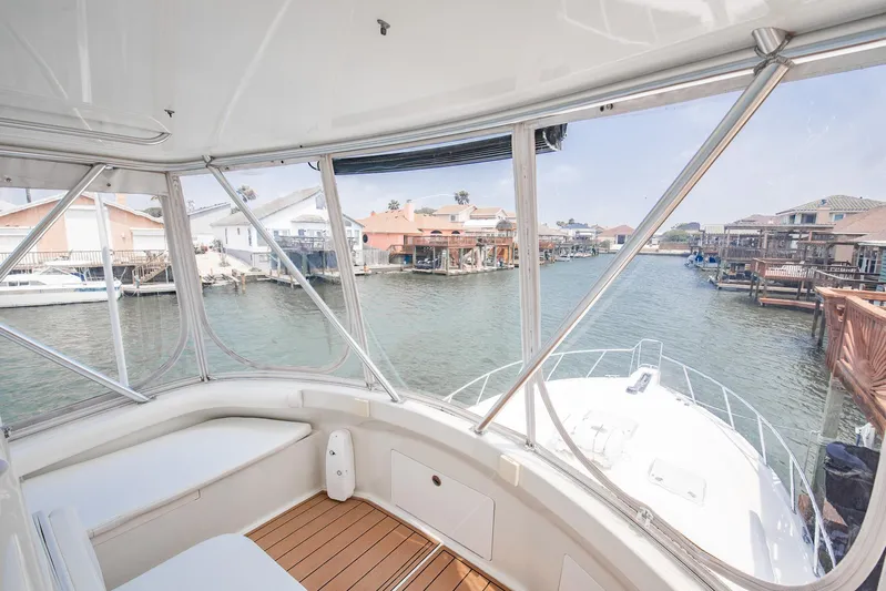 High Interest Yacht Photos Pics View from 2002 Cabo Convertible Painted boat, overlooking waterfront homes and docks.