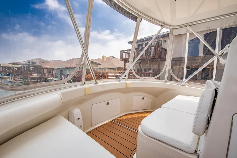 High Interest Yacht Photos Pics 2002 Cabo Convertible Painted boat interior with white seating and wooden flooring.