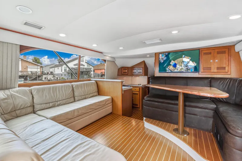 High Interest Yacht Photos Pics Interior of a 2002 Cabo Convertible Painted yacht with leather seating and wooden flooring.