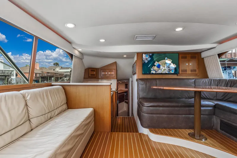 High Interest Yacht Photos Pics Interior of 2002 Cabo Convertible Painted yacht with leather seating and wooden flooring.