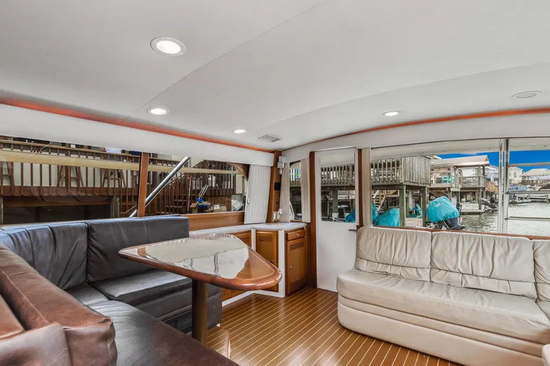 High Interest Yacht Photos Pics Interior of 2002 Cabo Convertible Painted yacht with leather seating and wooden flooring.