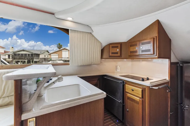 High Interest Yacht Photos Pics 2002 Cabo Convertible Painted yacht kitchen with sink, stove, and cabinets.