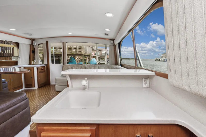 High Interest Yacht Photos Pics Interior of 2002 Cabo Convertible Painted boat with ocean view through large windows.