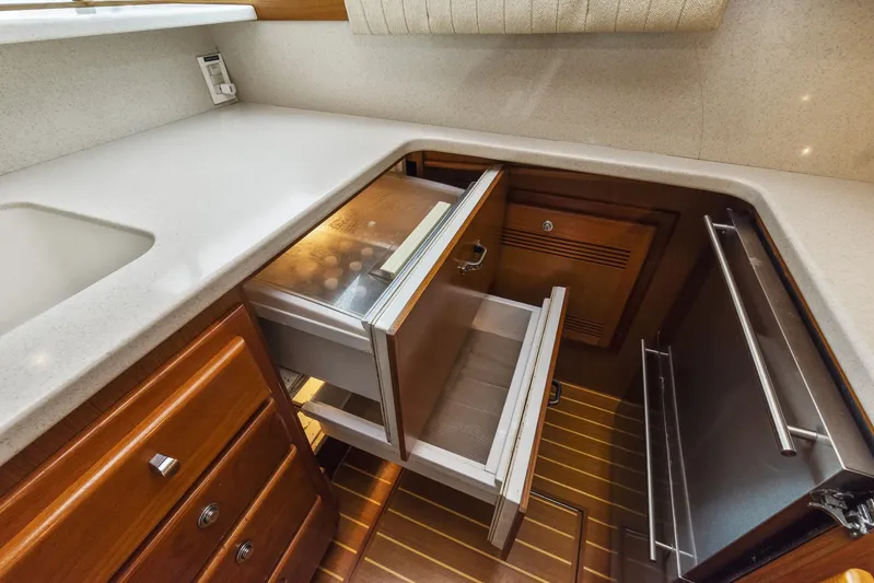 High Interest Yacht Photos Pics 2002 Cabo Convertible Painted yacht kitchen with open drawers and cabinets.