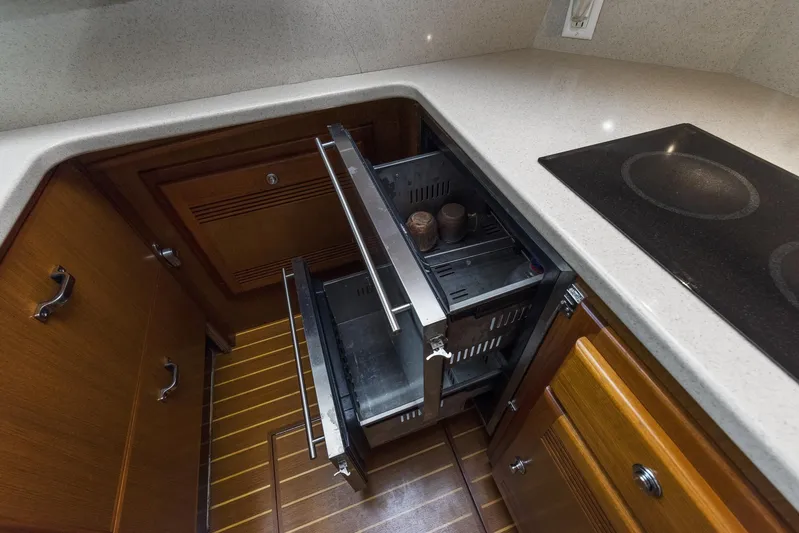 High Interest Yacht Photos Pics 2002 Cabo Convertible Painted yacht kitchen with open drawers and stove.