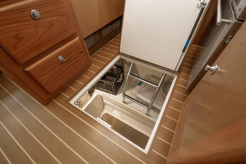 High Interest Yacht Photos Pics 2002 Cabo Convertible Painted boat interior with open floor storage compartment.