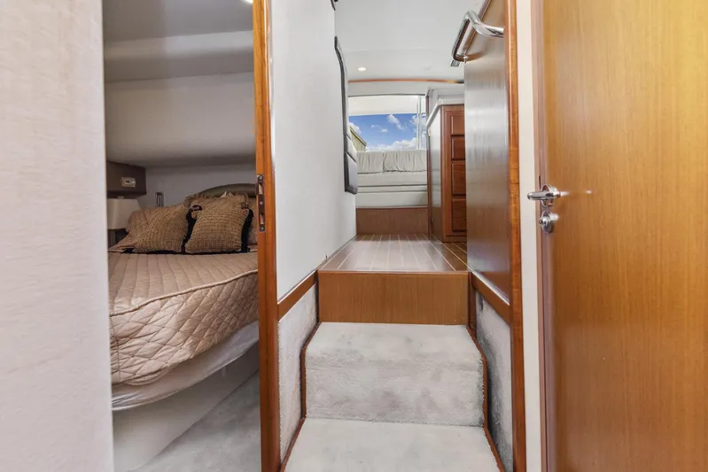High Interest Yacht Photos Pics Interior of 2002 Cabo Convertible Painted yacht with cozy bedroom and steps leading to upper deck.