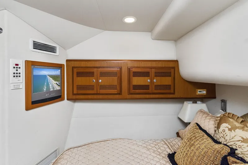 High Interest Yacht Photos Pics 2002 Cabo Convertible Painted yacht interior with TV and wooden cabinets.