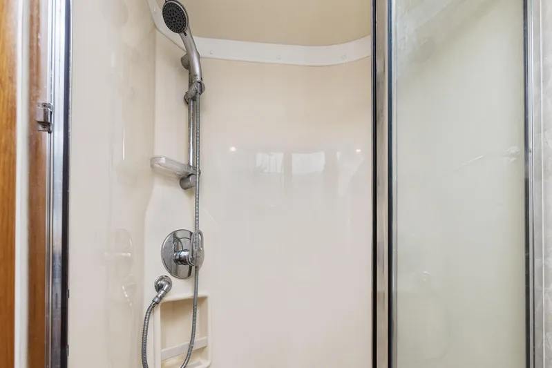 High Interest Yacht Photos Pics 2002 Cabo Convertible Painted shower with handheld showerhead and glass door.