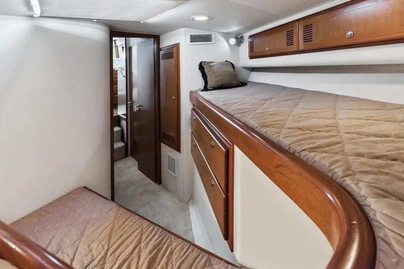 High Interest Yacht Photos Pics 2002 Cabo Convertible Painted yacht interior with bunk beds and wooden cabinetry.