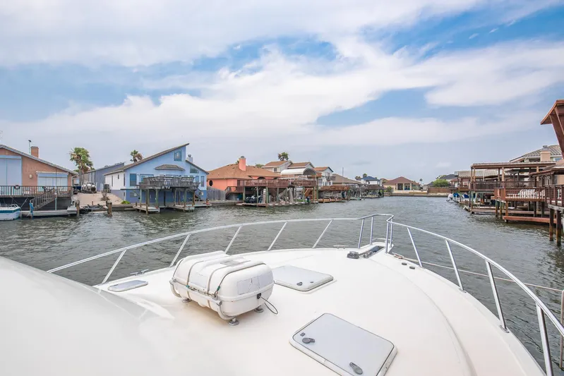 High Interest Yacht Photos Pics View from a 2002 Cabo Convertible Painted boat in a waterfront neighborhood.