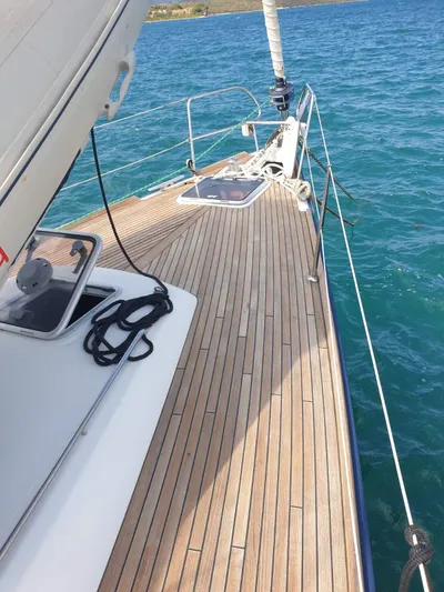  Yacht Photos Pics 2008 Beneteau Oceanis 50 sailboat deck with teak finish on blue water.