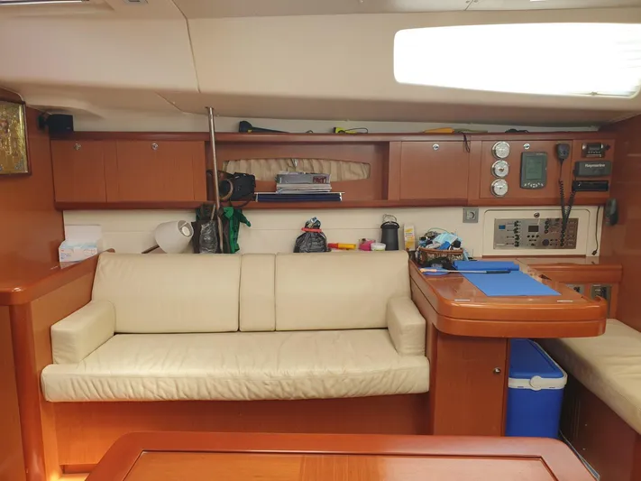  Yacht Photos Pics Interior of 2008 Beneteau Oceanis 50 yacht with beige sofa and navigation equipment.