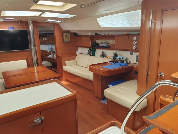  Yacht Photos Pics Interior of 2008 Beneteau Oceanis 50 yacht with wooden furnishings and seating area.