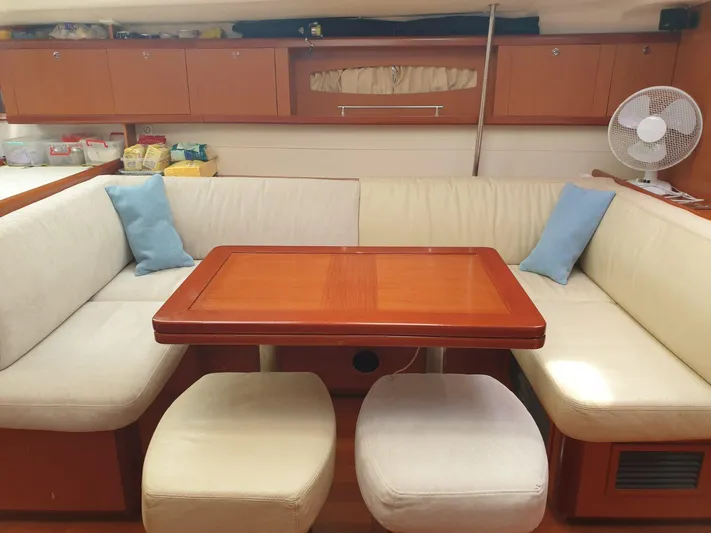  Yacht Photos Pics Interior of 2008 Beneteau Oceanis 50 yacht with cozy seating and wooden table.