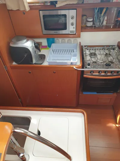  Yacht Photos Pics Galley kitchen in 2008 Beneteau Oceanis 50 yacht with stove, microwave, and sink.