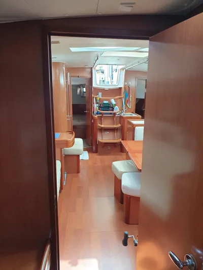  Yacht Photos Pics Interior of 2008 Beneteau Oceanis 50 yacht, featuring wooden furnishings and spacious seating area.