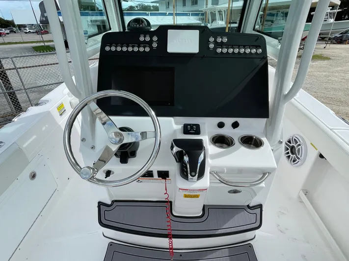 White Yacht Photos Pics 2023 Everglades 235CC boat console with steering wheel and control panel.
