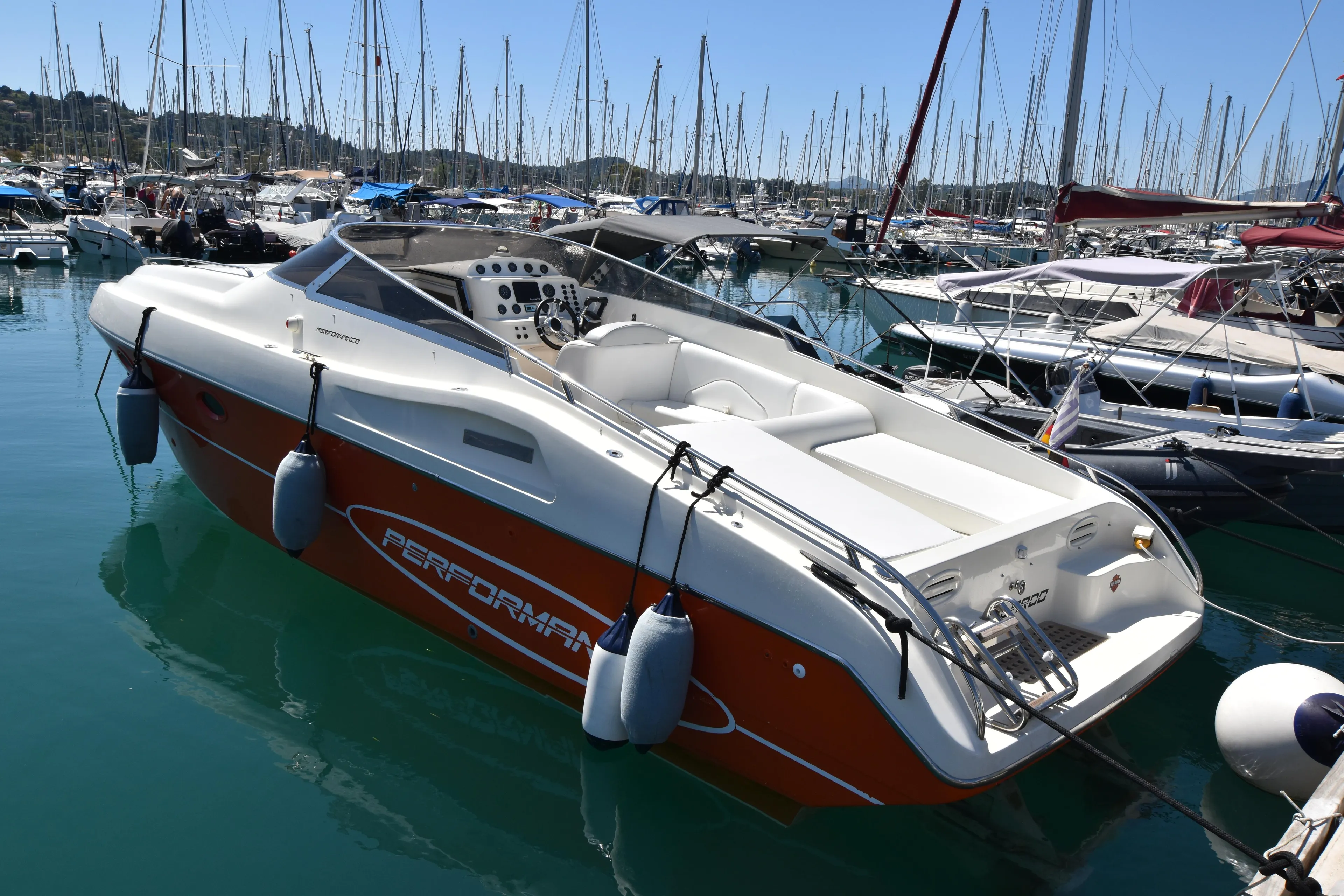 2003 Performance 907 boat docked in marina, surrounded by other vessels.
