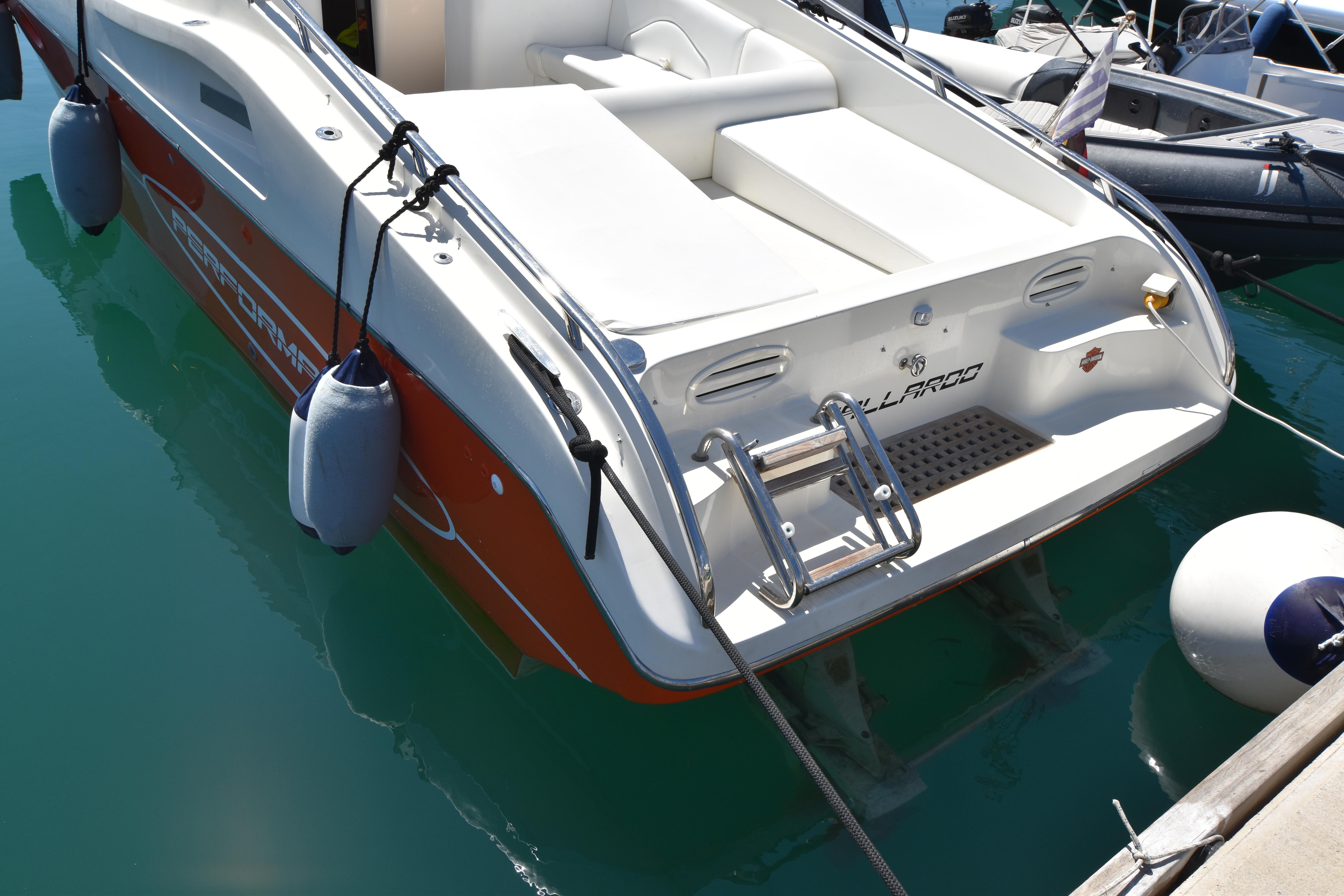 2003 Performance 907 boat docked, featuring white and red design with fenders and ladder.