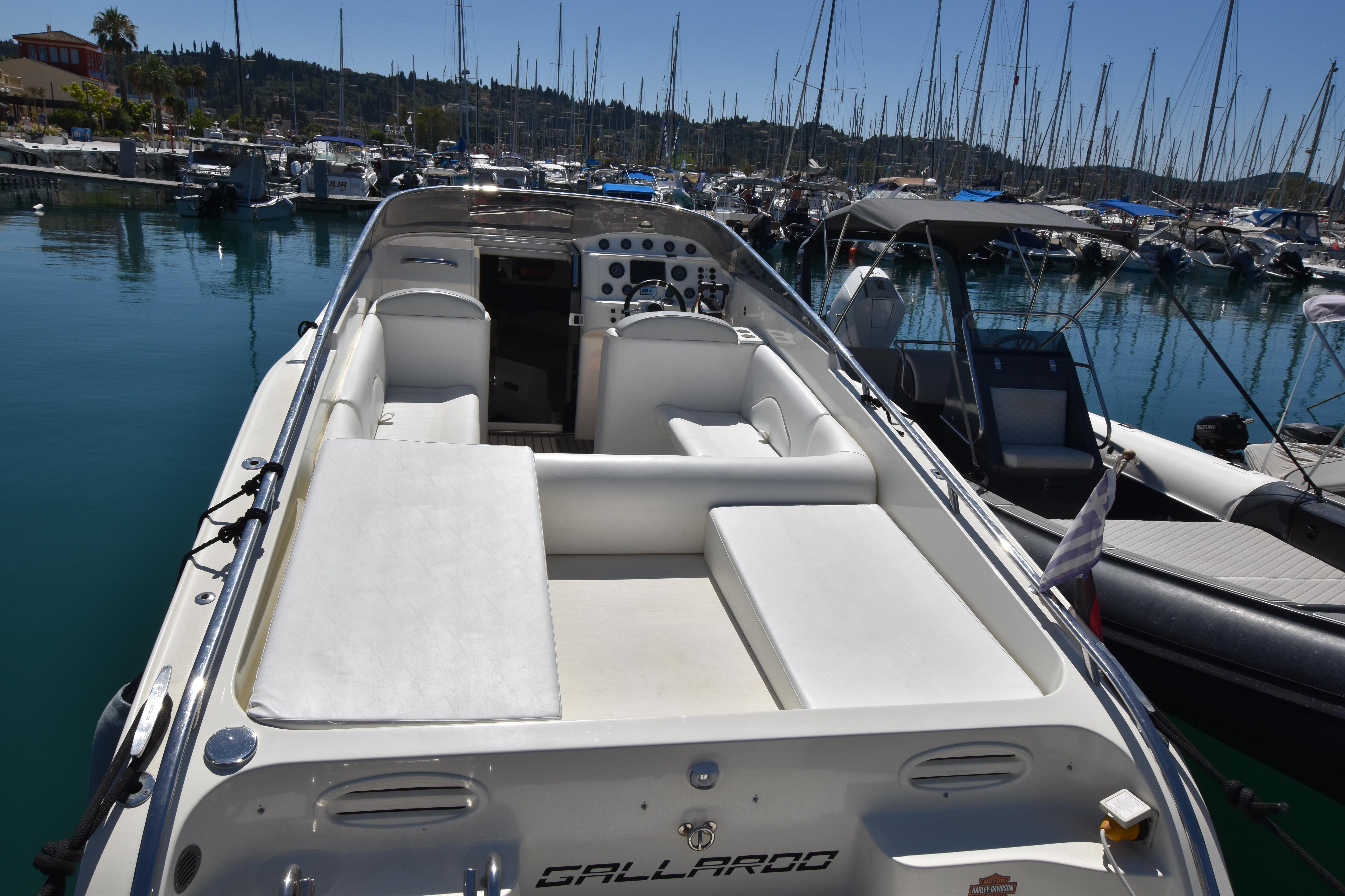 2003 Performance 907 boat docked in a marina, featuring sleek white seating and controls.