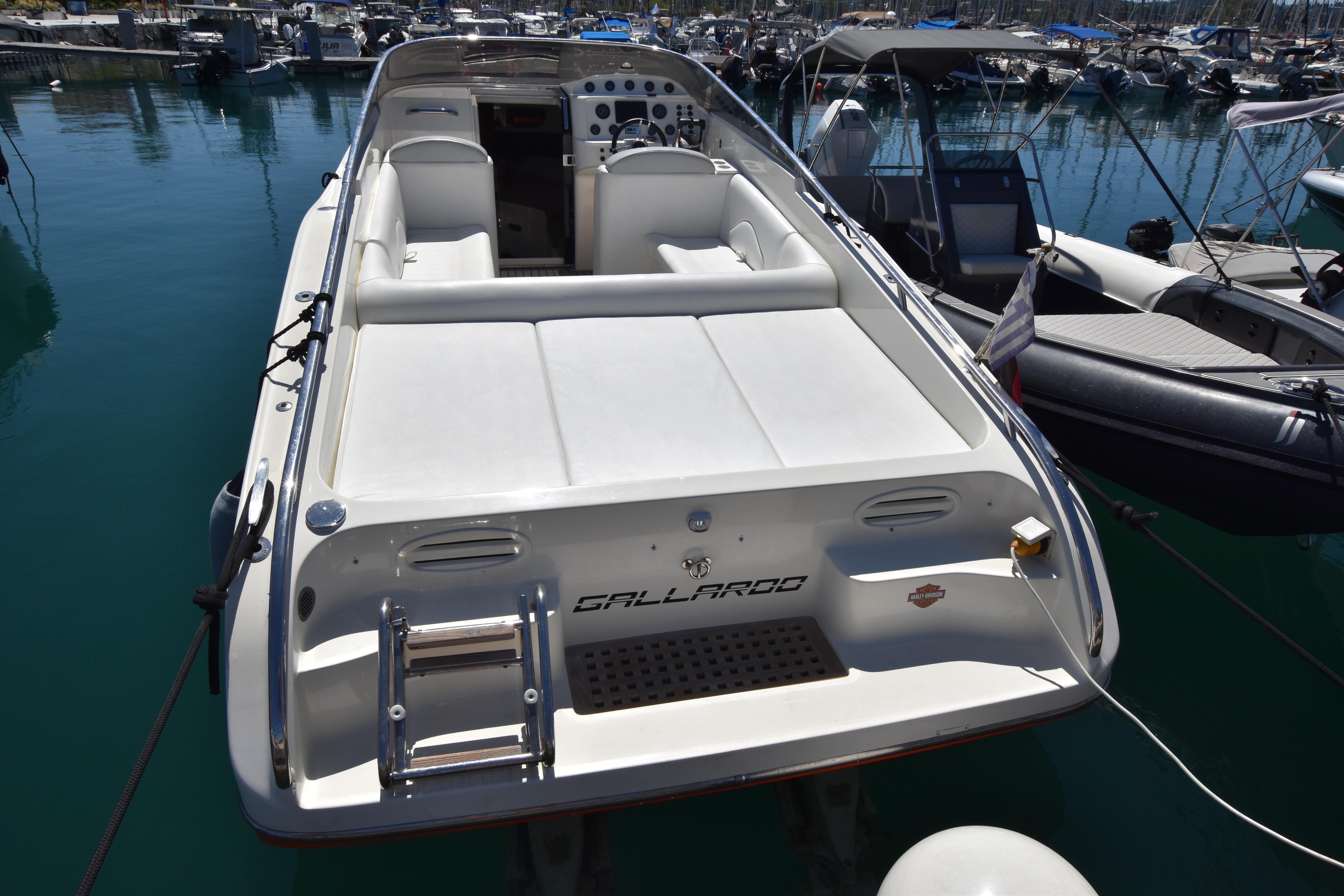 Luxury 2003 Performance 907 boat docked in marina, featuring sleek design and spacious seating.