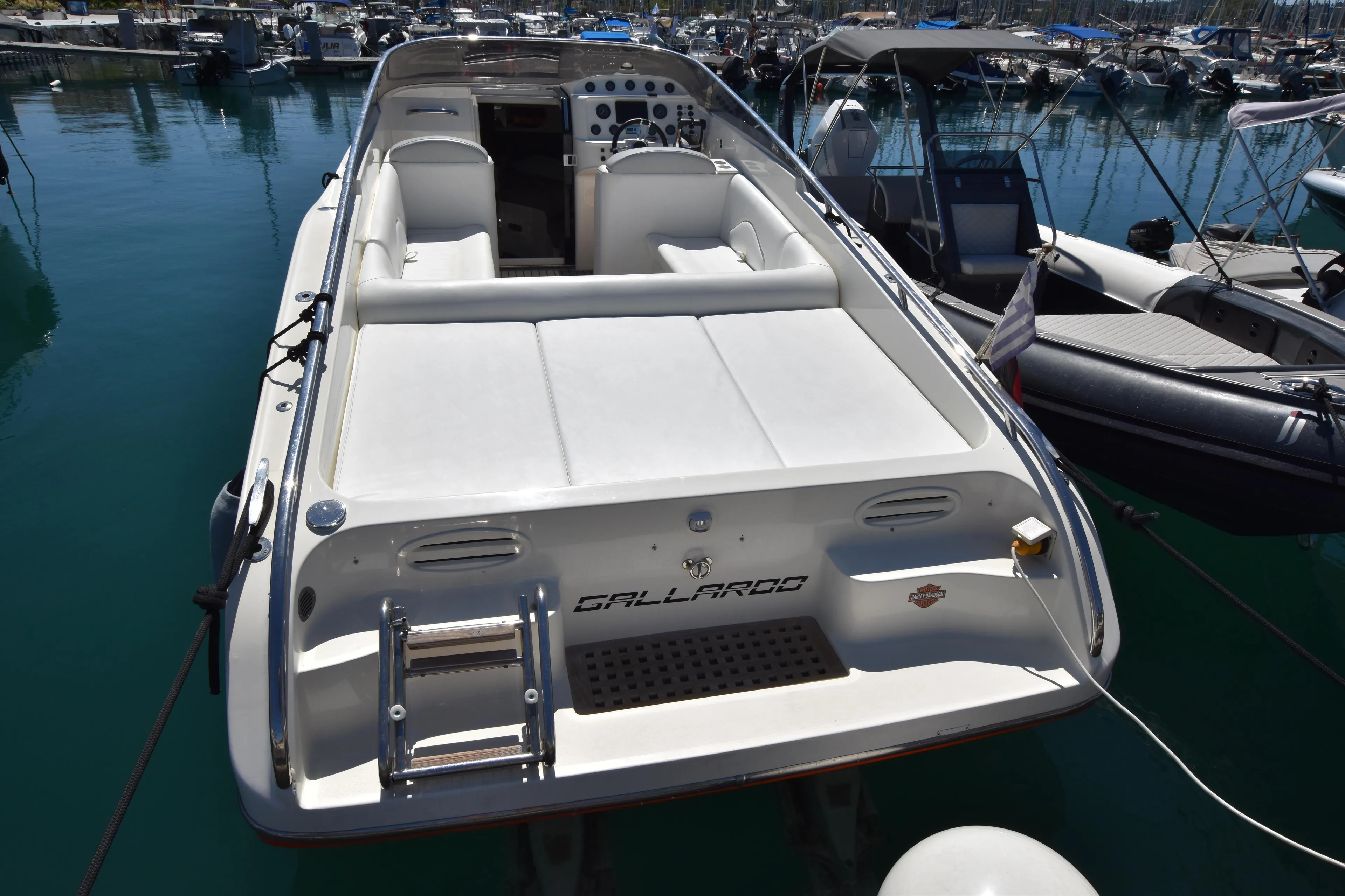 Luxury 2003 Performance 907 boat docked in marina, featuring sleek design and spacious seating.